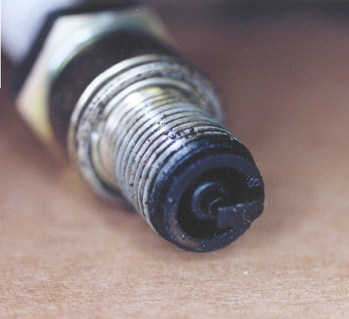 A wet fouled spark plug that's oily