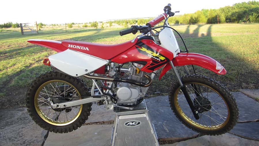 A 2002 Honda XR100 with an upgraded exhaust, intake and wheels