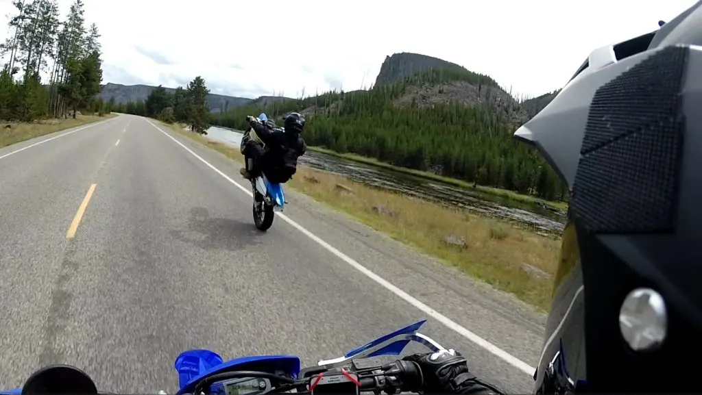 Riding a wheelie on a street legal supermoto dirt bike on the road