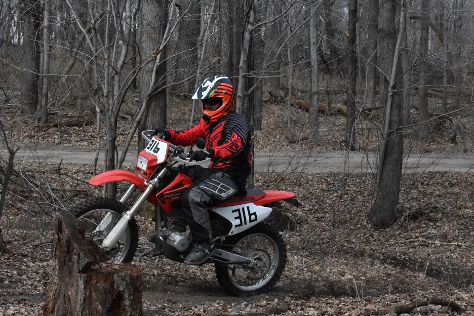Learning to safely ride a dirt bike on the trail.