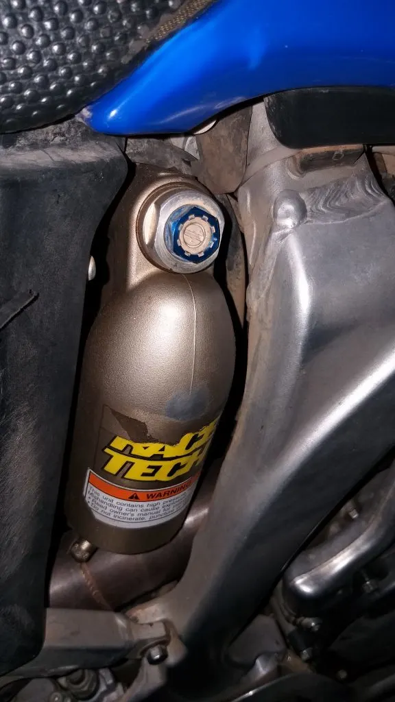 A fully adjustable Yamaha WR450F dirt bike shock with a remote reservoir