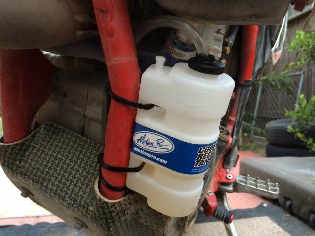 An overflow tank recovers the coolant leaking out of your dirt bike radiator.