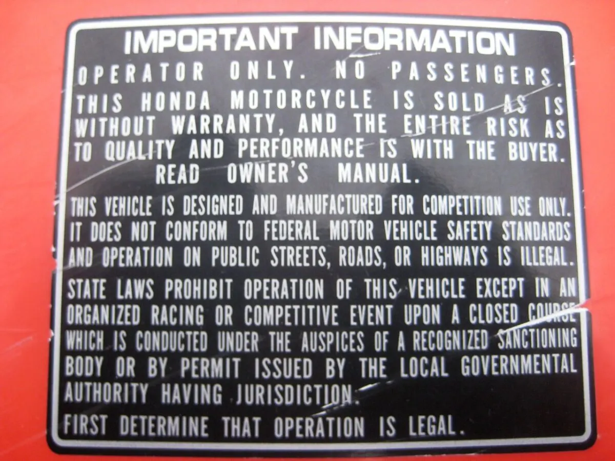 Important information sticker and disclaimer on a 2002 Honda CR125 rear fender from the manufacturer on where you can legally ride