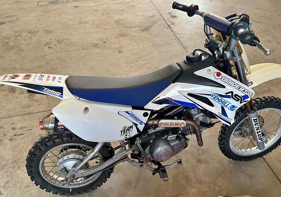 Yamaha TTR110 pit bike with an aftermarket exhaust and upgraded suspension